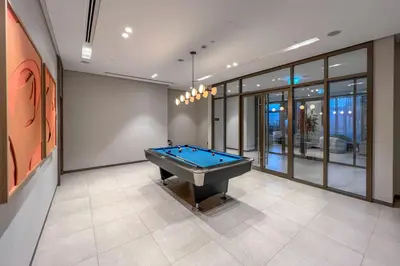 a room with a pool table in a house at Skyline View, Stay High Rise Luxury next to Burj in Dubai