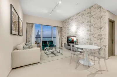 a living room with a table and a couch at Skyline View, Stay High Rise Luxury next to Burj in Dubai
