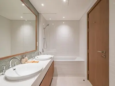 a bathroom with two sinks and a bath tub at TRPS - Central Park, City Walk, Al Wasl - 2BR Modern Residence - Elegantly Furnished to High Standards in Dubai