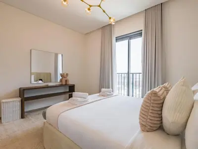 a white bedroom with a large bed and a mirror at TRPS - Central Park, City Walk, Al Wasl - 2BR Modern Residence - Elegantly Furnished to High Standards in Dubai