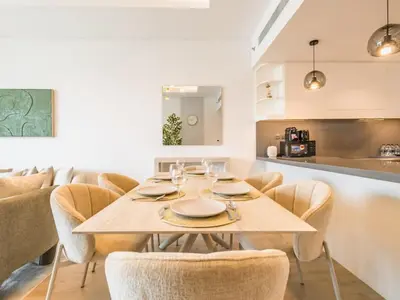a dining room with a table and chairs at TRPS - Central Park, City Walk, Al Wasl - 2BR Modern Residence - Elegantly Furnished to High Standards in Dubai