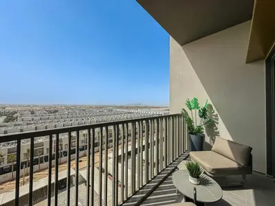 a balcony with a view of a train at Welhome - Chic Studio with Balcony & City Views in Dubai in Dubai