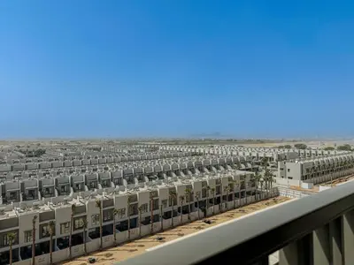 arial view of a large building in the desert at Welhome - Chic Studio with Balcony & City Views in Dubai in Dubai