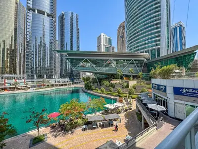 a pool in the middle of a city with tall buildings at Comfy Studio with Views Near Marina & Burj Al in Dubai