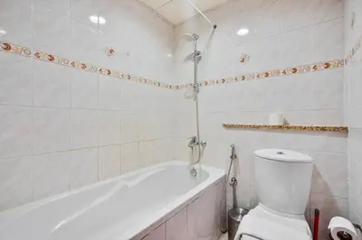 a bathroom with a white tub and a toilet at Comfy Studio with Views Near Marina & Burj Al in Dubai