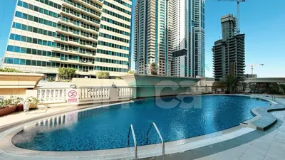 a large swimming pool in a city with tall buildings at Luxury 1 Br Marina Near Tram Ain Sea View Balcony in Dubai