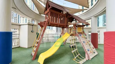 a childrens play area with a slide and a playground at Luxury 1 Br Marina Near Tram Ain Sea View Balcony in Dubai