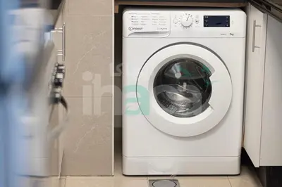 a white washing machine sitting next to a box at Luxury 1 Br Marina Near Tram Ain Sea View Balcony in Dubai