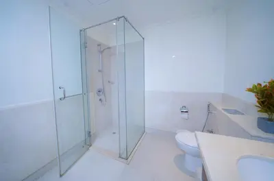 a bathroom with a glass shower and a toilet at Stunning 4BR Apartment with Full Burj Khalifa and Fountain View in Dubai