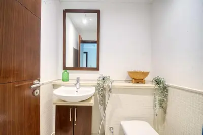 a bathroom with a sink and a mirror at The Smart Concierge - Delphine in Dubai