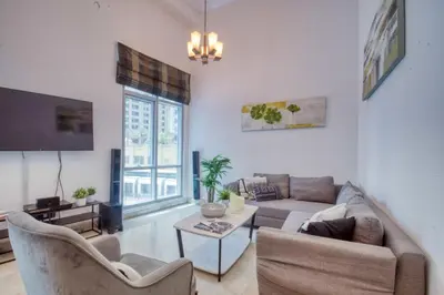a living room with a couch and a table at The Smart Concierge - Delphine in Dubai