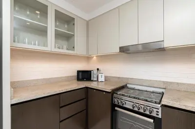 a kitchen with white cabinets and a stove top oven at Creek Side 18 I Harbor Views I in Dubai