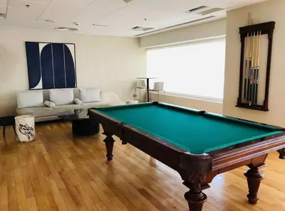 a room with a pool table and a couch at Downtown Apt - Near Burj Khalifa - Free Parking in Dubai