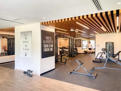 a gym with several treadmills and exercise equipment at Stylish Downtown Studio in Dubai