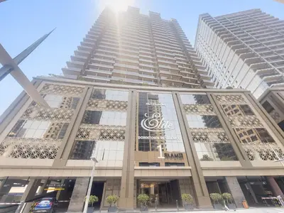 a tall building with a sign on it at Stylish Downtown Studio in Dubai