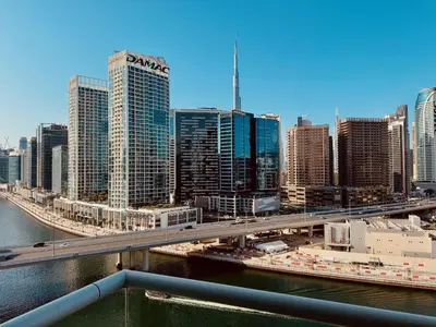 a view of a city with a bridge and buildings at Canal View Comfort Business Bay in Dubai