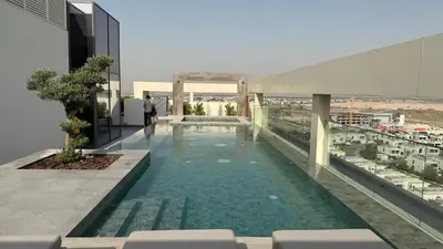 a swimming pool on the roof of a building at Brand new fully furnished studio in Dubai