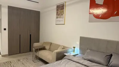 a living room with a couch and a chair at Brand new fully furnished studio in Dubai