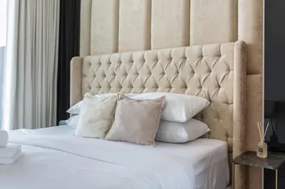 a bedroom with a large white bed with pillows at GuestReady - Charming haven in JVC in Dubai