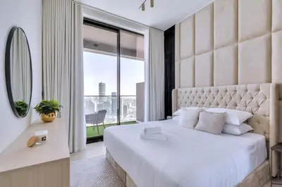 a bedroom with a large bed and a large window at GuestReady - Charming haven in JVC in Dubai