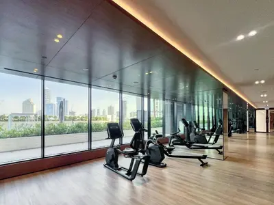 a gym with a bunch of exercise equipment in a building at GuestReady - Charming haven in JVC in Dubai