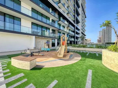 a playground in front of a building with a slide at GuestReady - Charming haven in JVC in Dubai