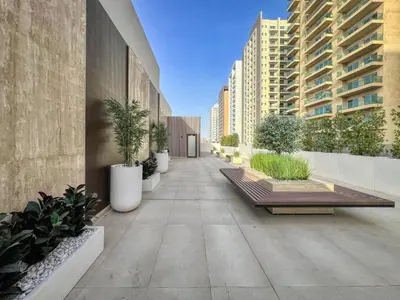 a walkway with potted plants on the side of a building at GuestReady – Modern comfort in JVC in Dubai
