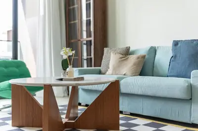 a living room with a blue couch and a table at GuestReady – Modern comfort in JVC in Dubai