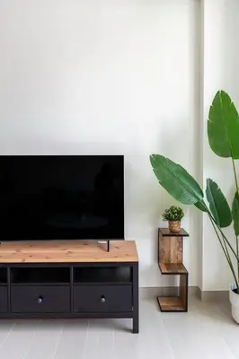 a living room with a flat screen tv and a table at GuestReady – Modern comfort in JVC in Dubai