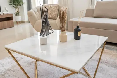 a white coffee table with vases and a wine bottle at 29 Boulevard by EMAAR 1BR 4min Walk to the Burj and Dubai Mall in Dubai