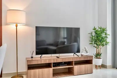 a living room with a television on a table at 29 Boulevard by EMAAR 1BR 4min Walk to the Burj and Dubai Mall in Dubai