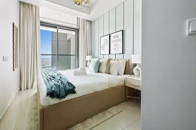 a bedroom with a large bed and a window at Sky High 1BR in City View with 41st Floor Views in Dubai