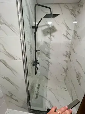 a shower with a glass door in a bathroom at PANTHEON ELYSEE III Elite Apartment Spacious luxury stay with huge pool , modern gym and Complimentary welcome pack in Dubai