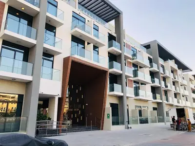 a large building with people standing outside of it at PANTHEON ELYSEE III Elite Apartment Spacious luxury stay with huge pool , modern gym and Complimentary welcome pack in Dubai