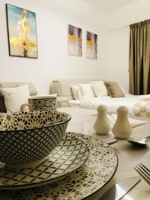 a living room with a large bowl on a table at PANTHEON ELYSEE III Elite Apartment Spacious luxury stay with huge pool , modern gym and Complimentary welcome pack in Dubai