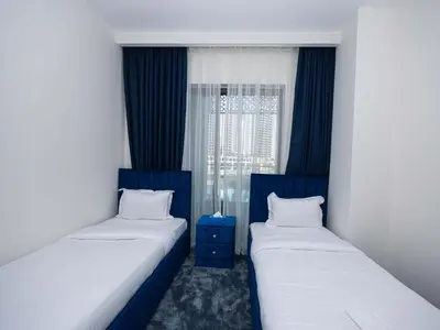 two twin beds in a room with a window at Beach Access, Burj Khalifa View, Family Friendly in Dubai