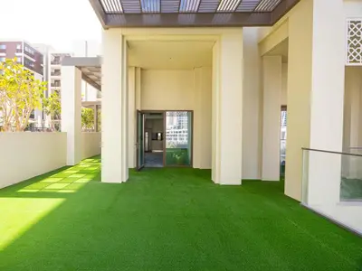 an empty hallway with green grass in a building at Beach Access, Burj Khalifa View, Family Friendly in Dubai