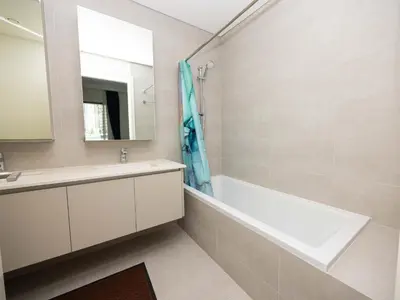 a bathroom with a tub and a sink and a mirror at Beach Access, Burj Khalifa View, Family Friendly in Dubai