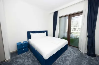 a bedroom with a large bed and a window at Beach Access, Burj Khalifa View, Family Friendly in Dubai