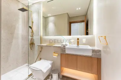 a bathroom with a toilet and a sink and a shower at Studio Near Dubai Autodrome & Trump Golf Club, Binghatti Amber, JVC By Deluxe Holiday Homes in Dubai