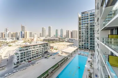 a view of the city from the balcony of a building at Studio Near Dubai Autodrome & Trump Golf Club, Binghatti Amber, JVC By Deluxe Holiday Homes in Dubai