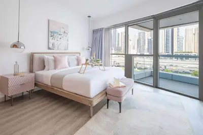 a bedroom with a large bed and a large window at Frank Porter - Saba 3 in Dubai