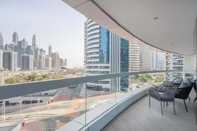 a balcony with chairs and a view of a city at Frank Porter - Saba 3 in Dubai