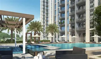 a swimming pool in front of a large building at Park Heights 2 Dubai Hills 1BR by Happy Season in Dubai