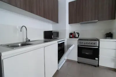 a small kitchen with a sink and a stove at Park Heights 2 Dubai Hills 1BR by Happy Season in Dubai