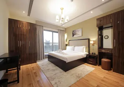 a bedroom with a bed and a desk and a piano at Luxury 2BR Apartment in Downtown Dubai Elite Stay in Dubai