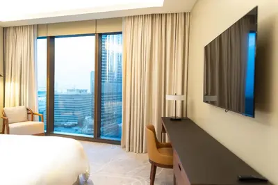 a hotel room with a bed and a desk with a television at ADDRESS Residences Dubai Opera at Downtown in Dubai
