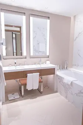 a bathroom with a tub and two sinks and a bath tub at ADDRESS Residences Dubai Opera at Downtown in Dubai