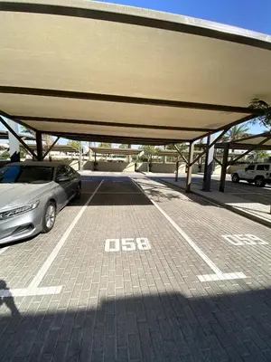 a parking lot with a car parked in it at Luxury 1-BR Escape in Dubai Hills Collective , 5 min from Mall in Dubai