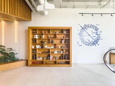 a shelf with vases and a clock on a wall at Luxury 1-BR Escape in Dubai Hills Collective , 5 min from Mall in Dubai